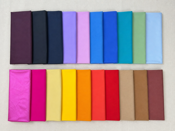 Twenty photographed nylon-spandex knit fabrics in two rows, with varied colors and finishes