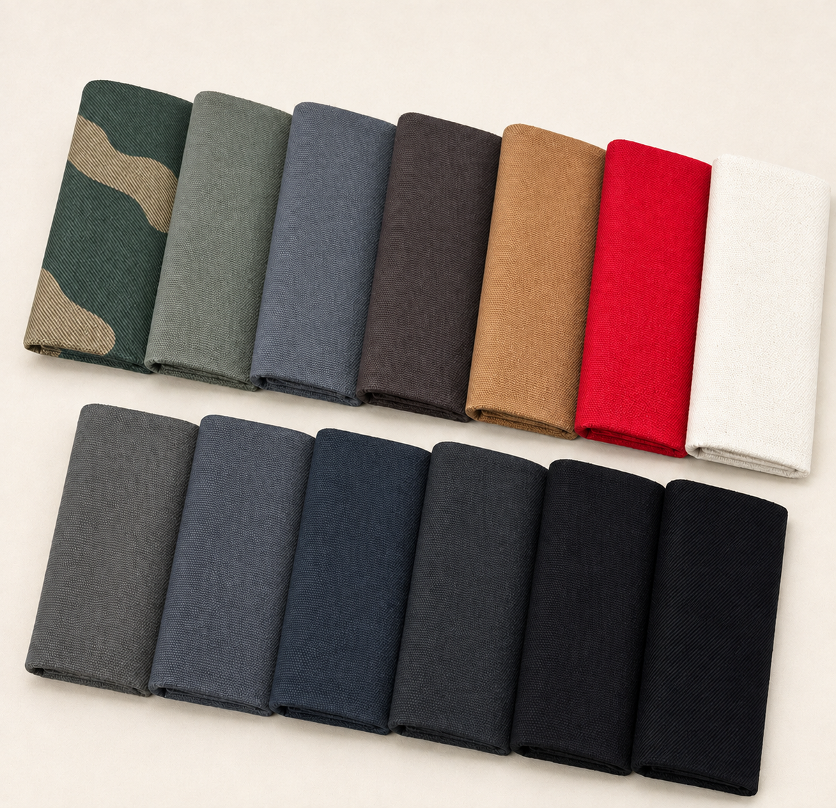 AI-restaged source composition of thirteen cotton canvas and twill fabric cuts, preserving their distinct weaves and source colors.