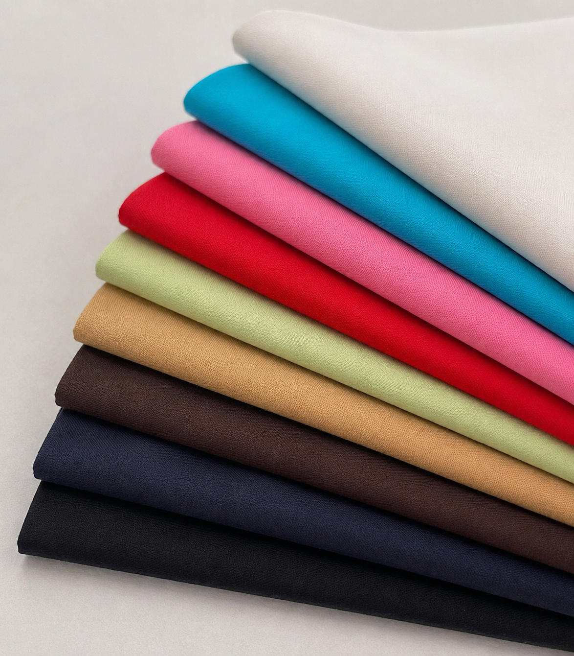 Fabric Lot AI-restaged source range photograph: nine folded fabrics in off-white, cyan, pink, red, pale yellow-green, tan, brown, navy and black.