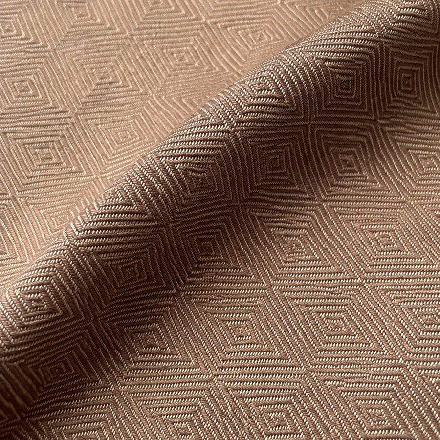 Brown and cream woven diamond jacquard in a shallow fold, AI-restaged from the source fabric.
